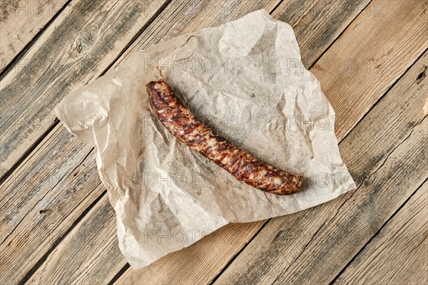 Top view of smoked dried pork sausage on wrapping paper