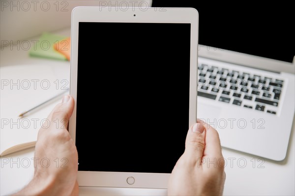 Technology desk concept with hands holding tablet. Resolution and high quality beautiful photo