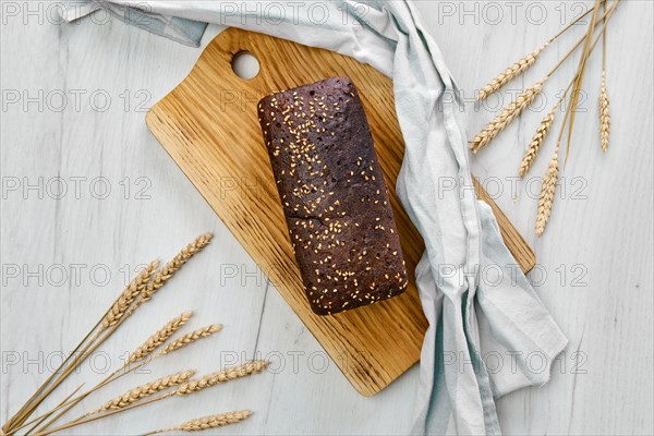 Top view of loaf of brown sourdough bread with sunflower seeds and sesame