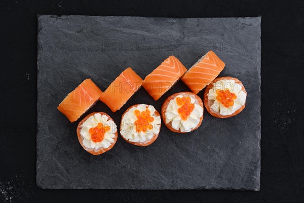 Rolls with salmon and cream cheese with caviar