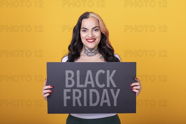 Beautiful woman holding a Black Friday sign. Commercial concept. Commerce