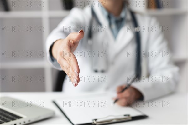 Close up doctor waiting to shake patients hand