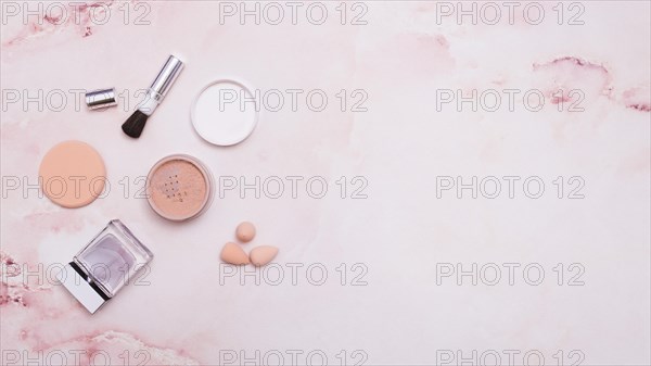 Face powder makeup brush powder puff bottle blender pink backdrop