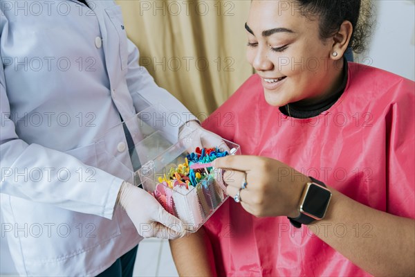 Female patient with dentist choosing dental braces