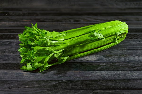 Fresh wet celery on an old kitchen table