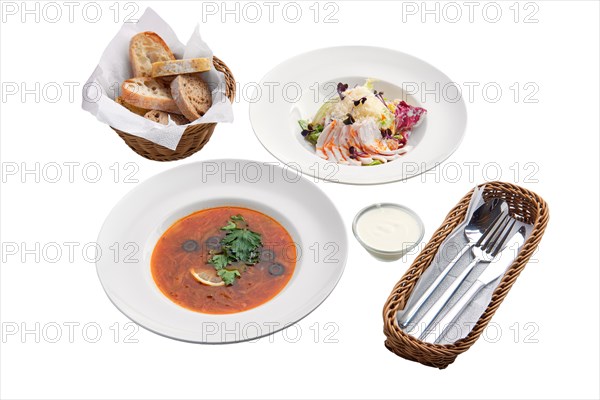 Solyanka soup and salad with cabbage and ham isolated on white background