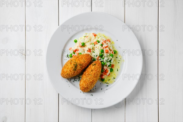 Top view of cutlet stuffed with cheese served with rice