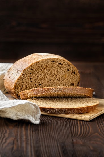 Rue brown bread on cutting board on the table