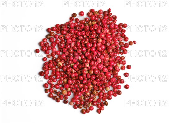 Heap of dry pink pepper on white background
