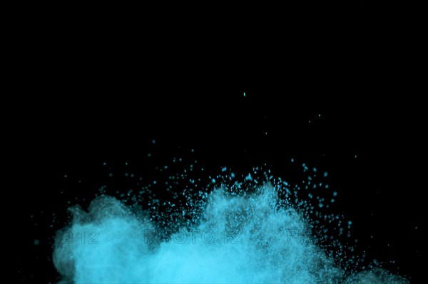 Flying blue colored dust particles