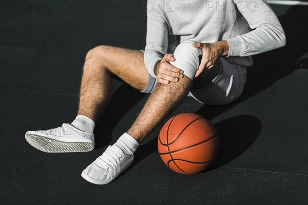 Unrecognisable player applying bandage knee. Resolution and high quality beautiful photo