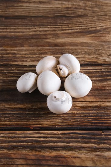 Fresh champignon on wooden background