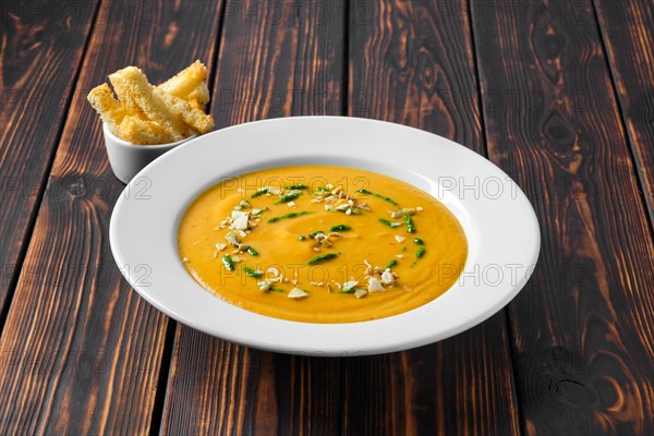 Aubergine soup puree with pumpkin seed and crouton