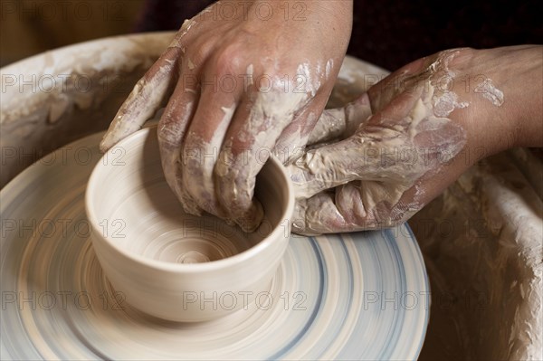 Dirty hands modeling clay potter s wheel