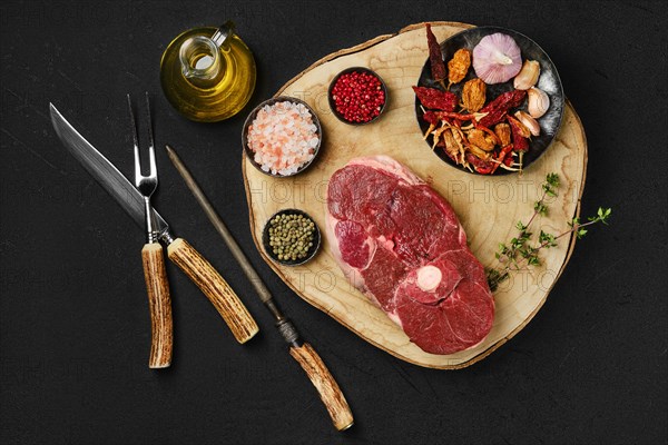 Top view of raw fresh lamb center cut leg steak with spice