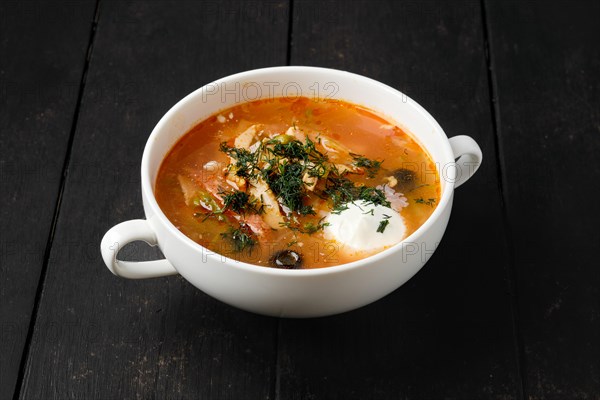 Cabbage and onion soup with sausage and olives