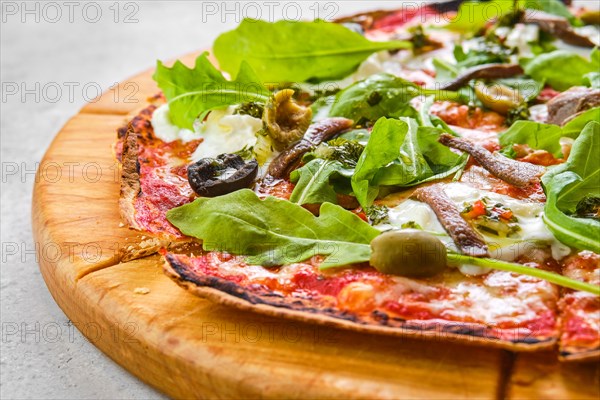 Thin-crust pizza dough with anchovies