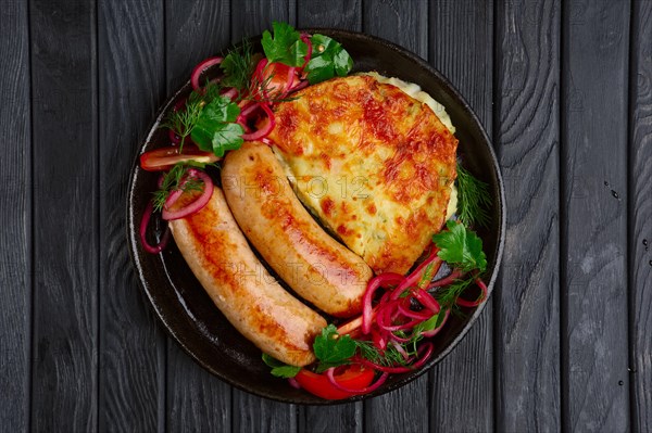 Fried homemade sausage with fried mashed potato