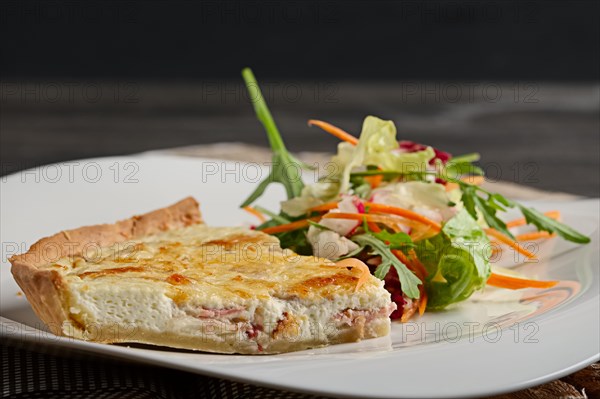 Plate of cheese and potpie with meat and salad