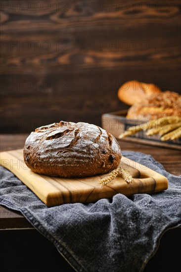 Fresh rye brown bread on wooden cutting board