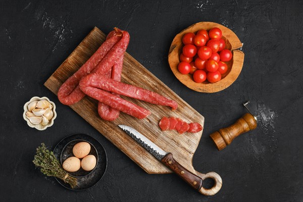 Air dried turkey sausage. Rustic lunch with eggs and tomato