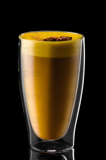 Double wall glass of hot chocolate with star anise isolated on black background