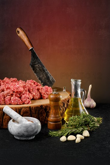 Chopped with butcher cleaver lamb ground meat on wooden stump