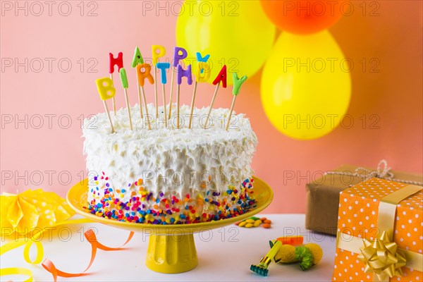 Close up of delicious birthday cake with accessories