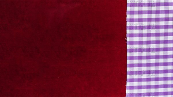 Elevated view chequered pattern textile plain burgundy fabric