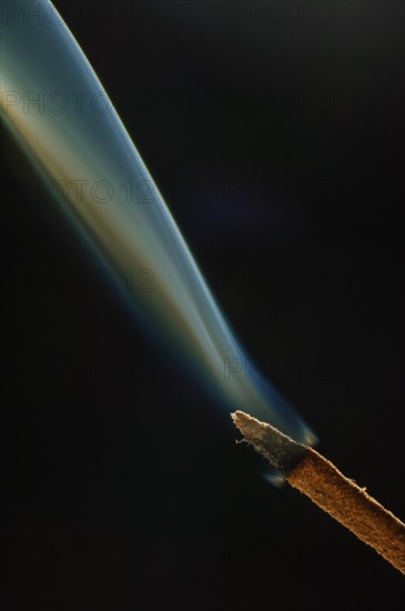 Trajectory of incense smoke in the air showing different shapes. France