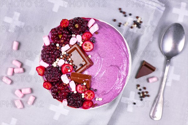 Fruit smoothie bowl decorated with healthy red raspberry
