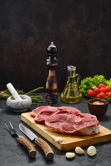 Lamb steaks with spice and knife and fork with horn handle