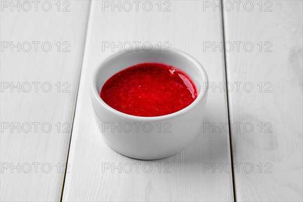 Strawberry sauce in ceramic gravy boat