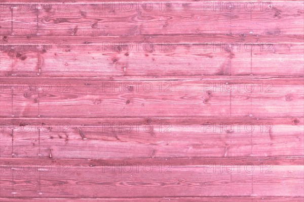 Pink wooden background with old painted planks