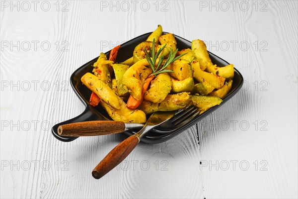 Spicy pumpkin and carrot baked in oven on ceramic plate