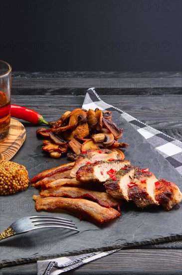 Fried pork fillet with mushrooms and slices of bacon served with pepper moonshine. Unhealthy but so tasty country food