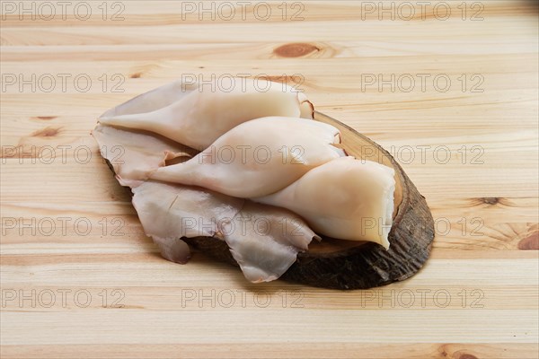 Top view of frozen pilled squid on wooden table