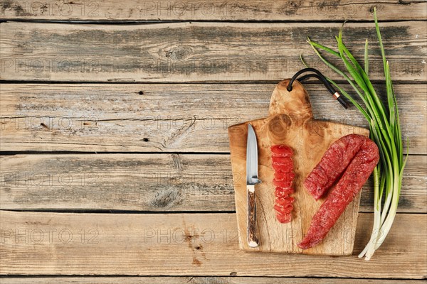 Top view of smoked dried turkey sausage on wooden cutting board