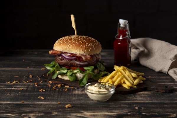 High angle burger with fries sauces table