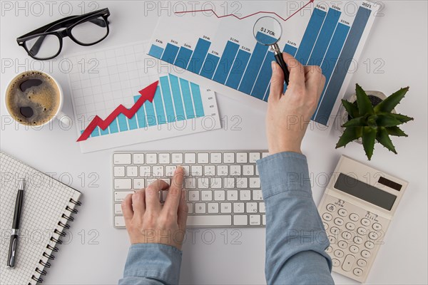 Top view office desk with growth chart hands with keyboard. Resolution and high quality beautiful photo