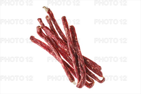 Overhead view of air dried deer and pork sausage isolated on white background