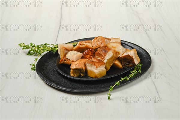 Frozen fresh boletus cut on pieces on black stone plate