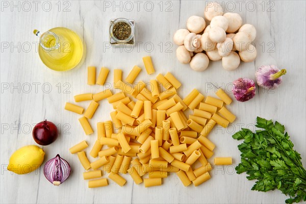 Overhead view of rigatoni pasta on wooden table