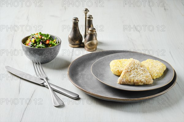 Semifinished squid cutlet in breading on a plate