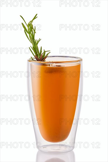 Hot sea buckthorn winter drink with rosemary isolated on white