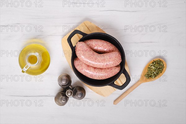 Top view of homemade classic raw beef sausage in cast iron skillet