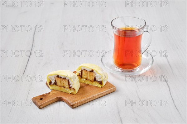 Sweet dessert mochi cut on half with fruit tea