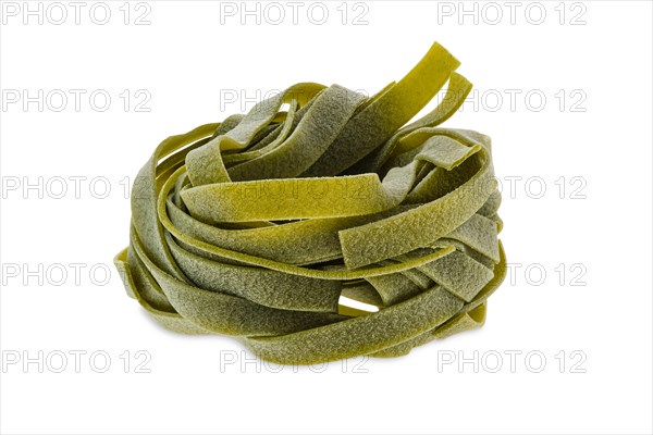 Nest noodles isolated on white background. Italian tagliatelle with spinach