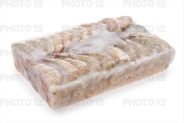 Raw tiger shrimp frozen in large ice cube isolated on white background