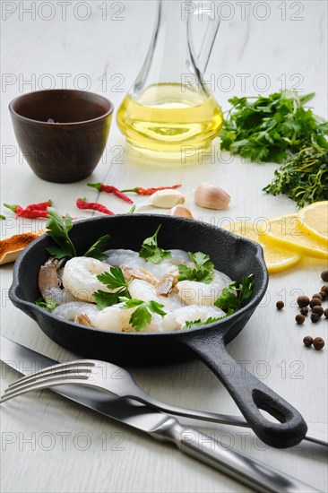 Top view of pan with fresh raw prawn with spice and herbs